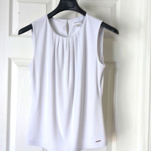 White sleeveless top.
